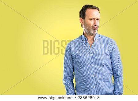 Handsome middle age man making funny face fooling