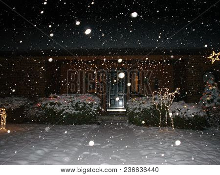 Winter Snowstorm At Night With Christmas Lights And Decorations On The Front Of A House, Conceptual