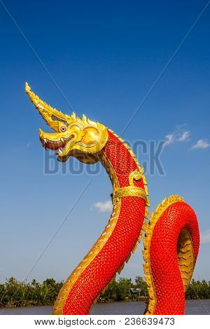 Heads Of Naka Or Naga Or Serpent Statue With Blue Sky In Buddhism Temple.