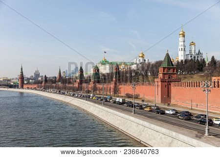 MOSCOW, RUSSIA - APRIL 5, 2018: Famous Russian historical Grand Kremlin Palace, Walls and Towers in front of modern Moscow International Business Center (MIBC) skyscrapers at Moscow City.