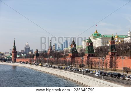 MOSCOW, RUSSIA - APRIL 5, 2018: Famous Russian historical Grand Kremlin Palace, Walls and Towers in front of modern Moscow International Business Center (MIBC) skyscrapers at Moscow City.