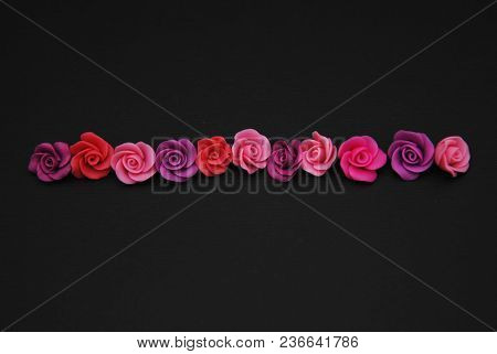 Mix Of Pink And Peach Fake Plastic Mini Rosess Flowers Black Background Copy Space. Craft, Art, Hobb