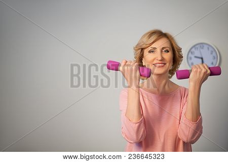 Half Length Image Of Woman Making Exercise With Drumbells. Healthy Lifestyle Concept.