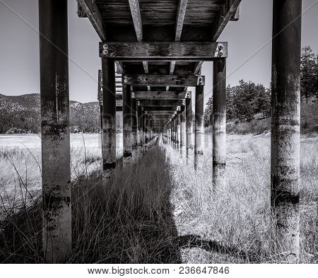 A Wooden Boardwalk Over A Dried Up Lakebed. A Victim Of The Drought And Time.