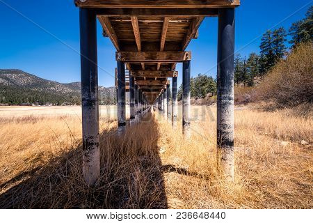 A Wooden Boardwalk Over A Dried Up Lakebed. A Victim Of The Drought And Time.