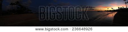 On The Edge Of Night And Day, A Panorama Of The Sunset Over The Coastline Invokes A Feeling Of Myste