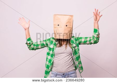 Happy Unknown Woman With A Paper Bag On Her Head On White Background.