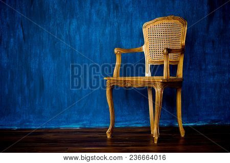 Old Chair On A Blue Wall Background