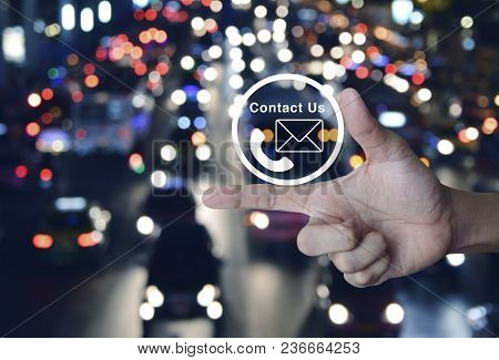 Telephone And Mail Icon Button On Finger Over Blur Colourful Night Light City With Cars, Contact Us 