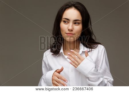 Beautiful Girl In A White Shirt Shows Emotions. On A Light Background.