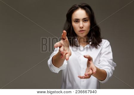 Beautiful Girl In A White Shirt Shows Emotions. On A Light Background.