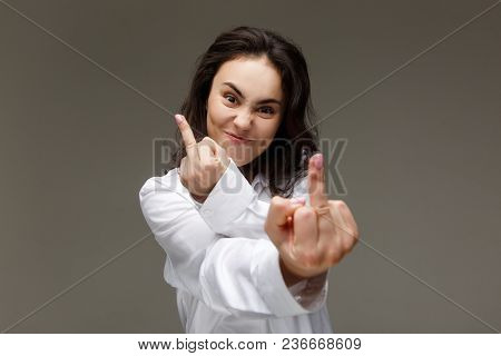 Beautiful Girl In A White Shirt Shows Emotions. On A Light Background.