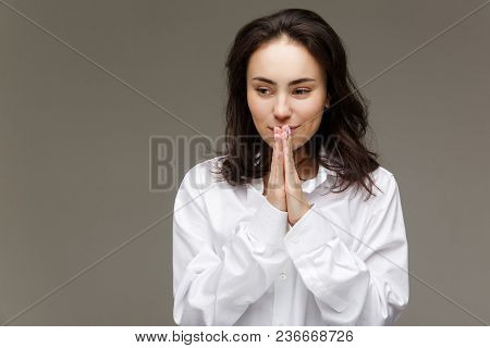 Beautiful Girl In A White Shirt Shows Emotions. On A Light Background.