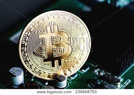 Golden Bitcoin On The Electronic Computer Processor Board. The Concept Of Electronic Currency. Close