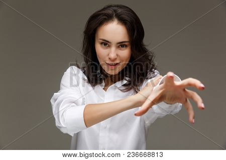 Beautiful Girl In A White Shirt Shows Emotions - Smile, Fun. On A Light Background.