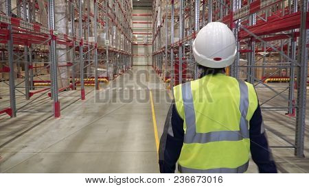 Shot Of Female Industrial Worker In The Hard Hat Walking Through Heavy Industry Manufacturing Factor