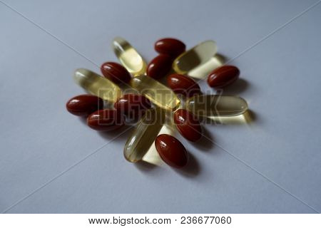 Fistful Of Fish Oil And Lutein Capsules