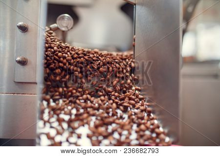 Image of falling roasted coffee beans from roaster