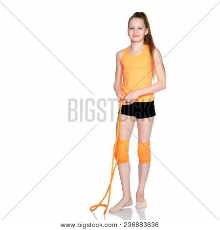 A Girl Gymnast Performs Exercises With A Skipping Rope. The Concept Of A Healthy Lifestyle, Sports E