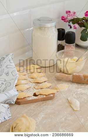 Douhg Preparation For Cooking Dumplings. Womens Hand Cutting Up Dough. Womens Hands In A Process Of 