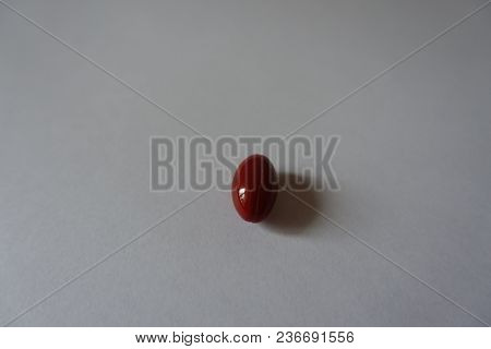One Red Capsule Of Lutein Dietary Supplement