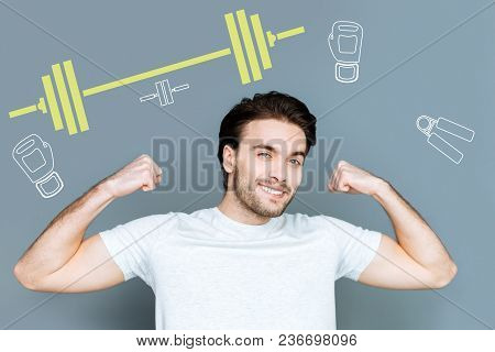 Feeling Strength. Cheerful Emotional Strong Student Feeling Satisfied With His Good Shape After Doin