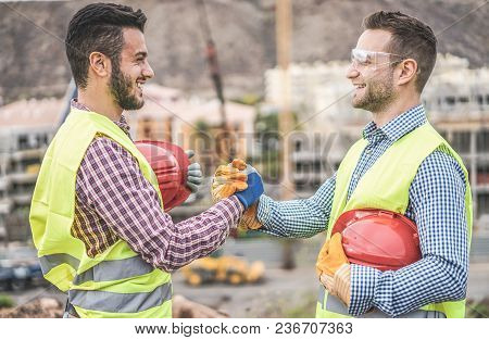 Builders On Residential Construction Site Making A Deal - Happy Workers Are Satisfied Of Their Plan 