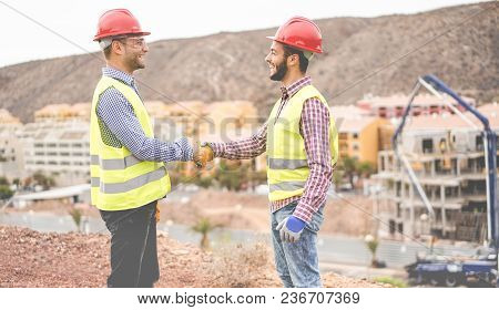 Builders On Residential Construction Site Making A Deal - Happy Workers Are Satisfied Of Their Plan 