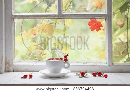 Tea With Berries Of A Dogrose On A Windowsill
