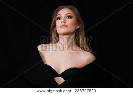 Beautiful Young Self Confident Diva Lady With Long Blonde Hair In Long Coat Posing In Studio, Dark B