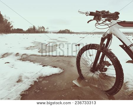 Bike Drowned In Muddy Pool Within Winter Trip. Broken Pieces Of Ice Around Freeze Terain Tyre, Wide 
