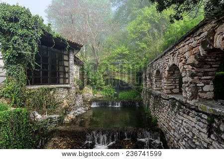 Old Stone Building And A Gazebo In The Forest.
