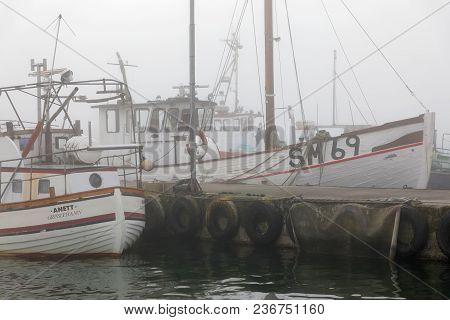 Grisslehamn, Sweden - Jul 12, 2017: Foggy Day In The Harbor, Fishing Boats Waiting For Better Wether