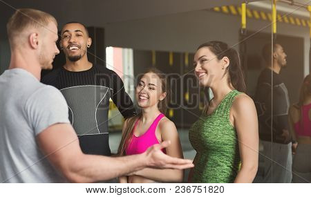 Group Of Young Sporty Smiling Multiethnic People Having Fun, Talking After Workout, Friends Having R
