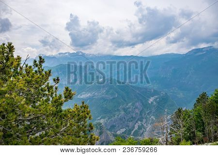 The Tops Of The Picturesque Mountains Are Covered With White Snow.