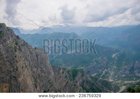 The Tops Of The Picturesque Mountains Are Covered With White Snow.