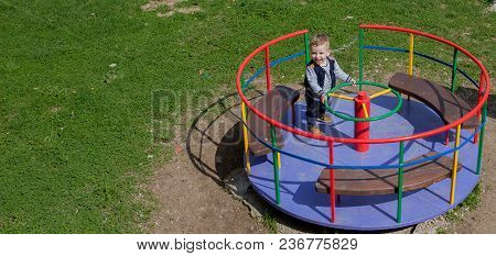 The Child Is Riding A Carousel, A View From Above.