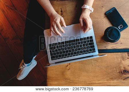 Overhead Flat Lay Of Laptop Keyboard And Coffee Cup In Cozy Hipster Cafe. Freelancer Female Hands Ty