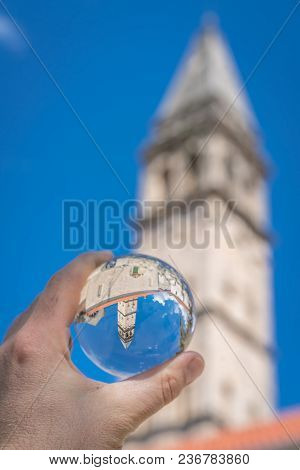 Saint Nikola Church Tower Reflected In A Glass Ball Held By A Tourist, Perast, Kotor Harbor, Montene