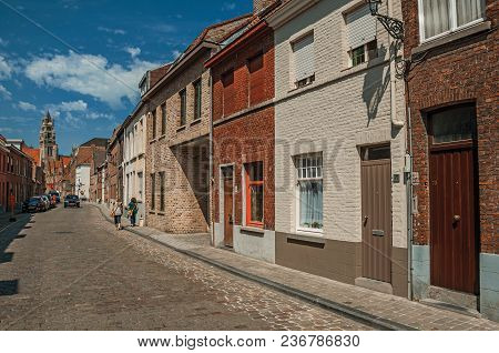 Bruges, Belgium - July 05, 2017. Old Brick Houses And Steeple In Street Of Bruges. With Many Canals 
