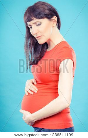 Sad Woman In Pregnant With Stomach Pain Holding Hands On Her Belly, Concept Of Health Care, Sufferin