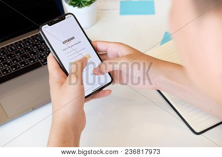 Chiangmai,thailand 22 Feb 2018 : Man Holding New Iphone X On Hand Open Mazon Application,amazon Is A