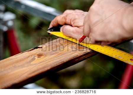 Man Draws A Stroke Along A Glazed Wooden Board By Using A Try Square And A Pencil