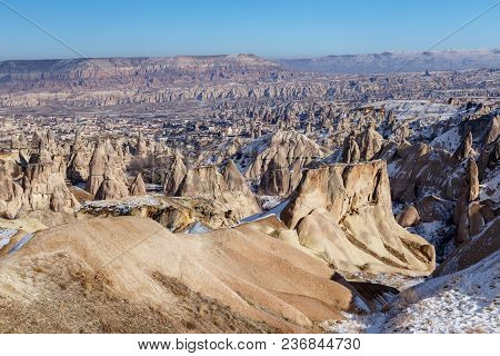 View Of Cappadocia In Winter With Blue Sky And Many Rock Chimnies
