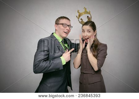The Leader Man Dresses The Golden Crown On The Winner Head Isolated On Gray Background. Award Ceremo