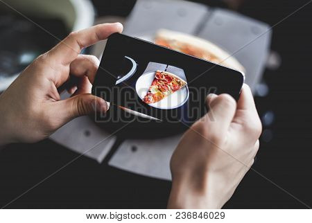 A Young Man Taking Photo Of Pizza On Smartphone, Photographing Meal With Mobile Camera. Top View.