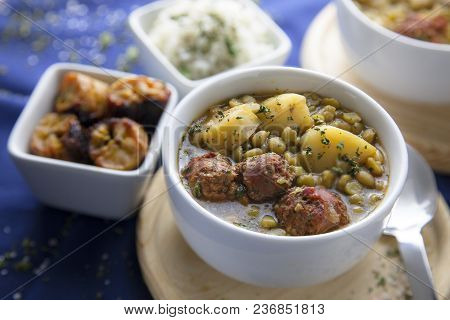 Delicious Stew Of Green Peas, Potatoes And Spanish Chorizo, With White Rice And Parsley
