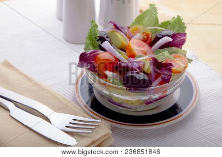 Delicious Vegetable Salad With Lettuce, Tomato, Onion And Black Olives