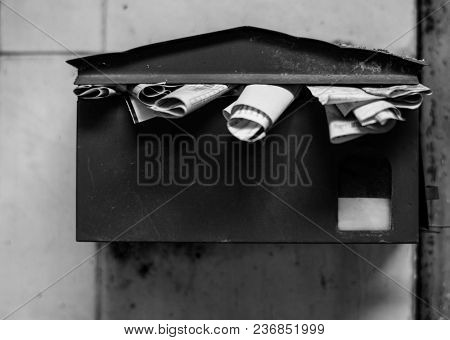 An overfull old post box