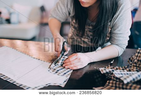 Tailor Girl Cuts Cloth With Scissors. Sewing Business